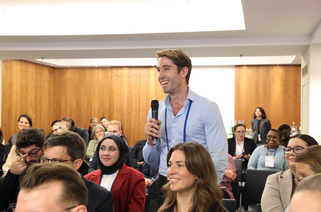 Speaker presenting at a global health conference